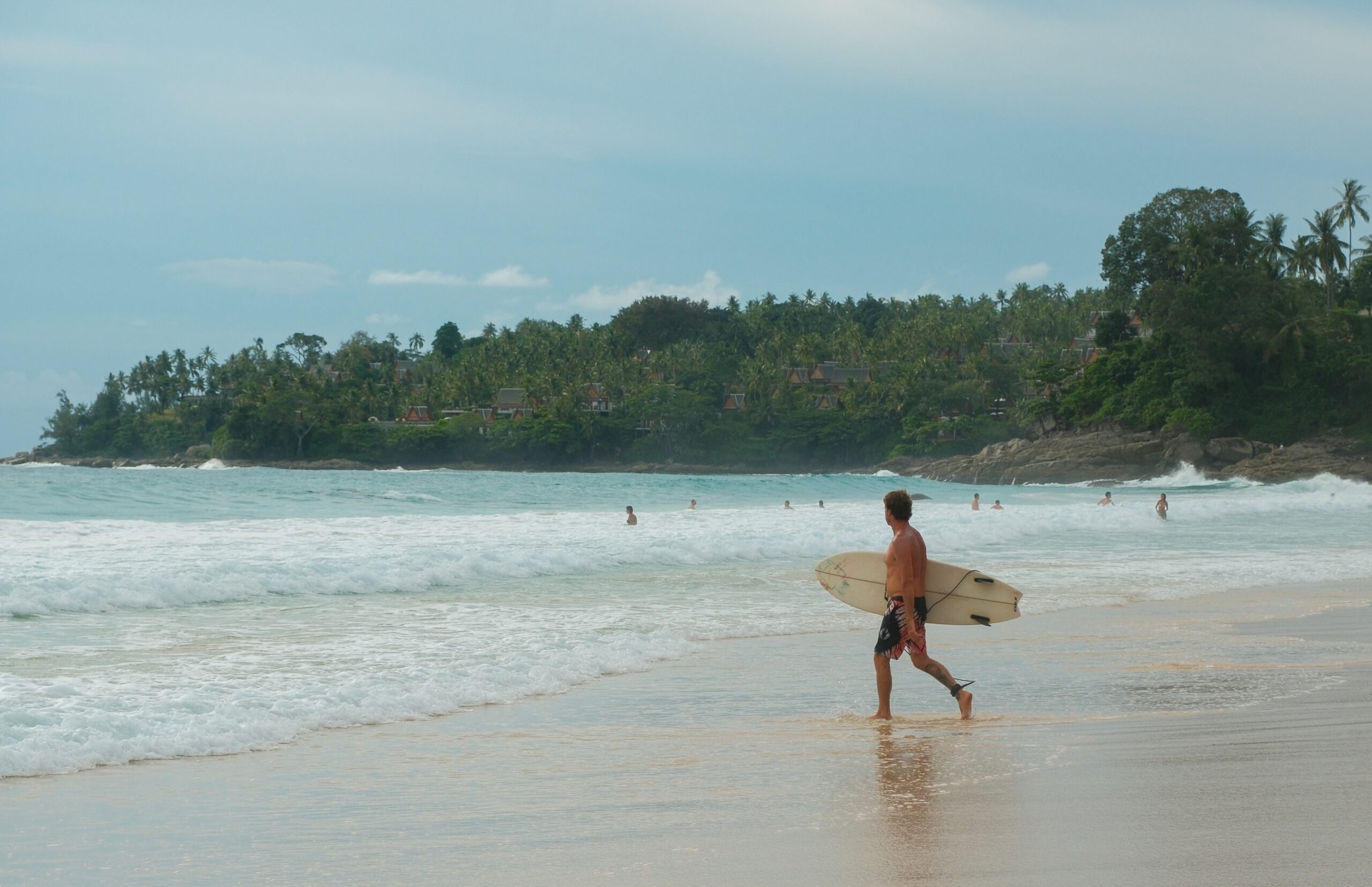 A surfer ready to take the waves in Surin Beach