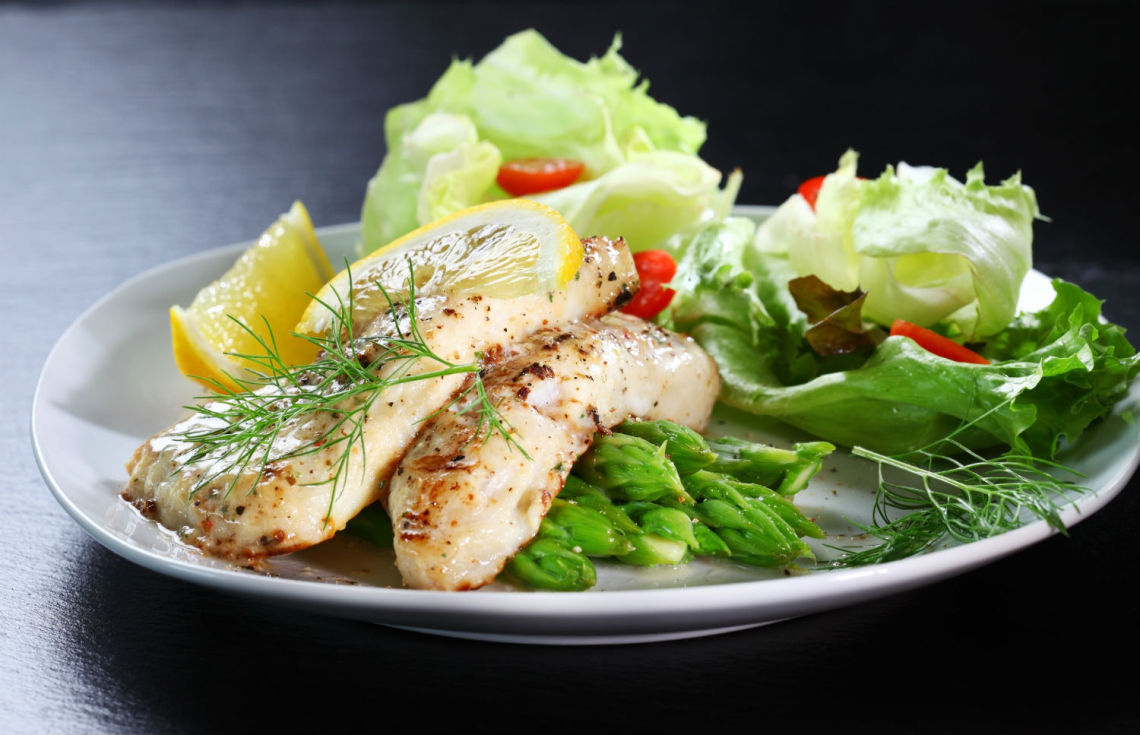 Fish on green asparagus with salad -- The Luxury Signature