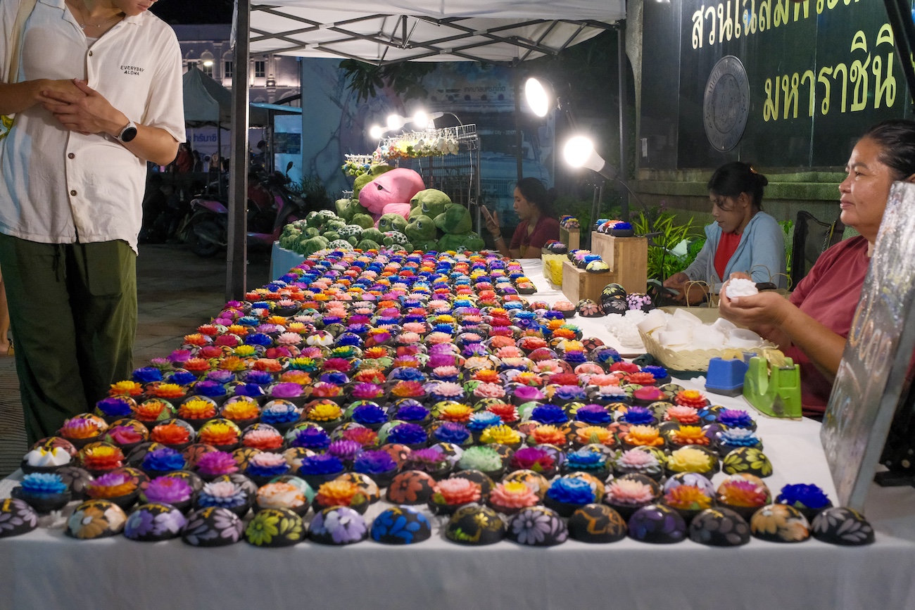 A vendor selling soap flowers at the Sunday Walking Street market in Phuket Old Town.