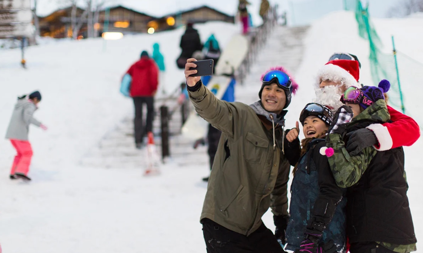 A family taking a selfie with Santa Claus
